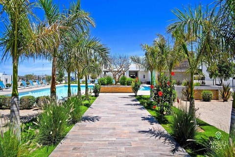 Step into paradise! Enjoy our refreshing pool surrounded by lush greenery—perfect for relaxing or soaking up the sun.