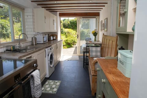 Kitchen with range cooker, washing machine and microwave
