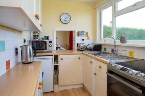 Kitchen with electric cooker, microwave, kettle, toaster and fridge