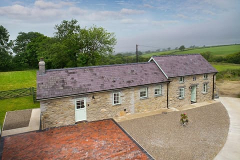 Front of Bwthyn Briallen with paved and gravel parking areas