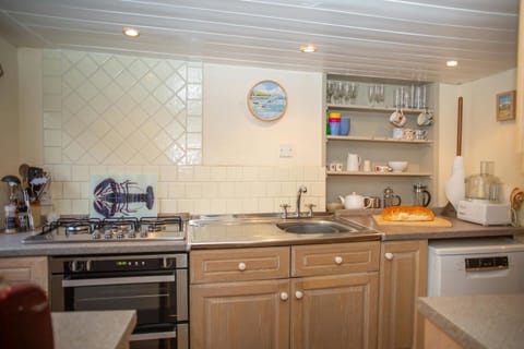 Kitchen, cooker, sink, shelves with utensils