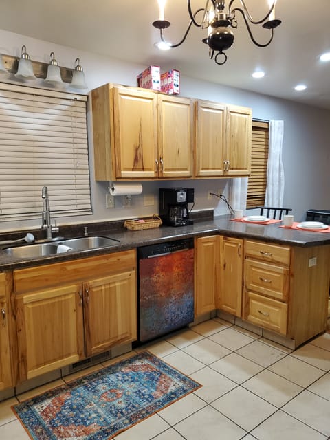 Open kitchen with bar area for eating. 