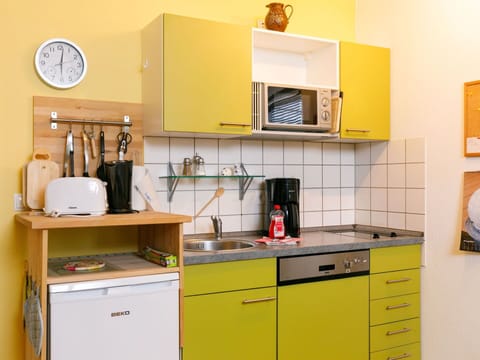 Cabinetry, Property, Countertop, Drawer, Interior Design, Lighting, Kitchen, Yellow, Kitchen Appliance, Clock