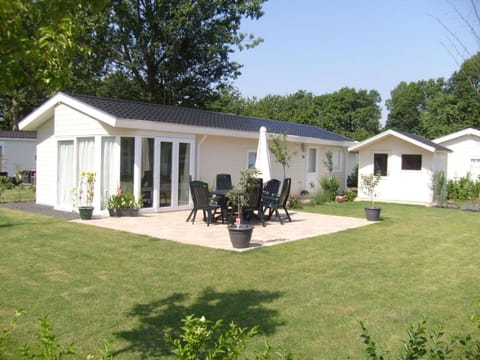 Plant, Building, Sky, Shade, Tree, Land Lot, Chair, House, Grass, Window