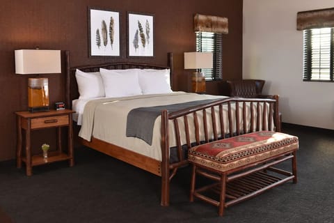 Unwind in a cozy log-frame bed with warm lodge style.