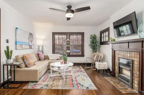 Living room features a cozy couch, reading material, a smart tv, and ample room
