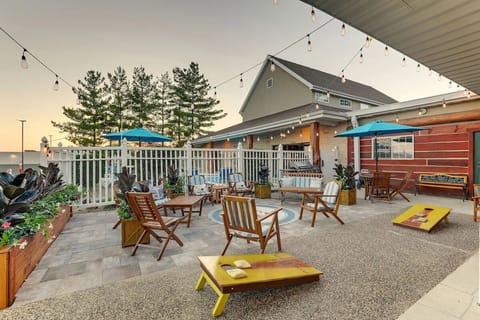 Linger outside under café lights with games and seating.