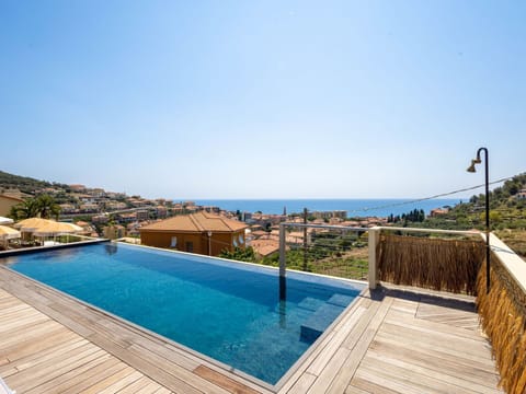 Sky, Property, Furniture, Water, Seaside Resort, Azure, Shade, Chair, Outdoor Furniture, Wood