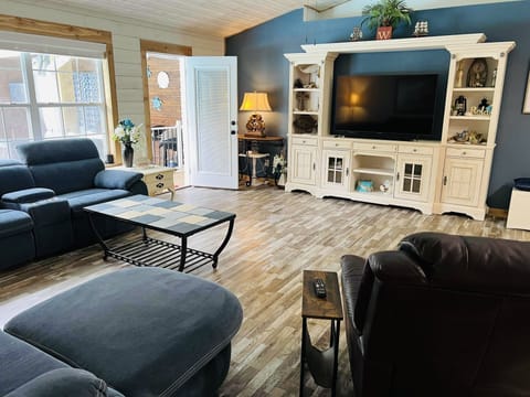 Oversized living room with smart TV and surround sound. 