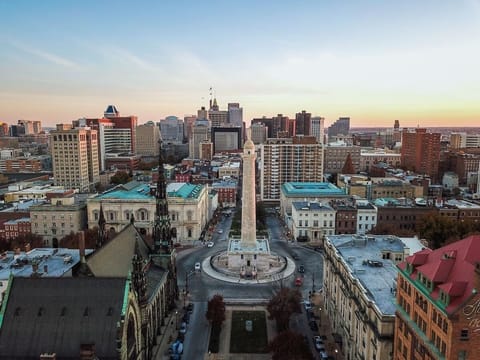 Explore the city steps away, framed by a sunset skyline