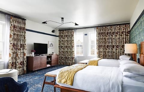 Settle into two plush beds beneath bold, stylish decor.