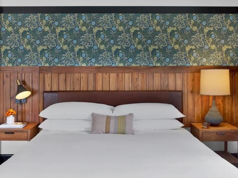 Drift off on crisp linens framed by warm, wood accents.