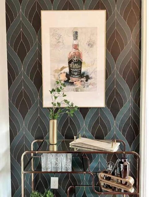  Elegant bar cart with bourbon-themed art and glassware