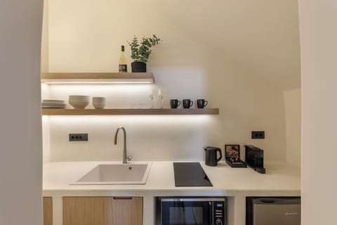 Kitchen with microwave, Nespresso machine, kettle and mini fridge.