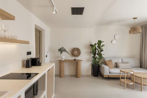 Kitchen with mini fridge, Nespresso machine microwave and stovetop