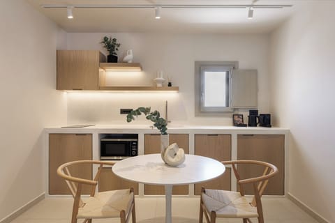 Dining table and kitchen with mini fridge, microwave, Nespresso machine, kettle