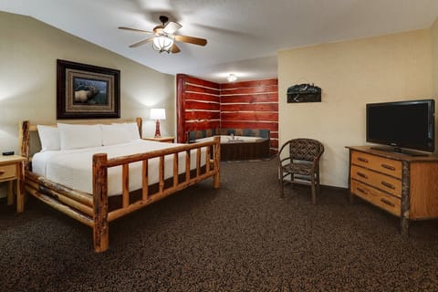 Unwind in the rustic king bedroom with private hot tub.