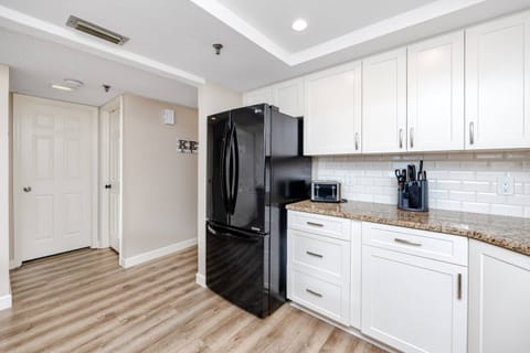 Updated Kitchen with Sleek Black Appliances and Modern Cabinetry