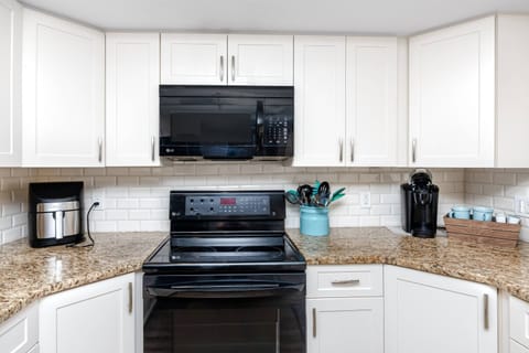 Updated Kitchen with Sleek Black Appliances and Modern Cabinetry