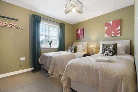 Featuring two comfortable single beds dressed with fresh linen, this bright and welcoming space benefits from natural light through the windows and includes a TV for added entertainment and relaxation.