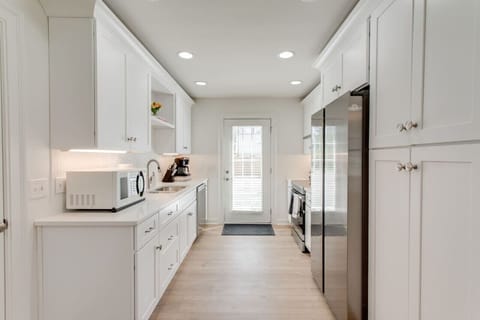 The kitchen has a door that leads to the backyard.
