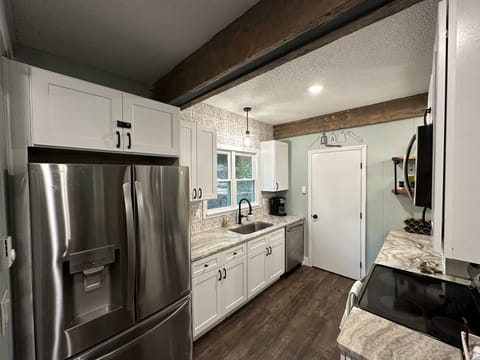 Laundry room located through kitchen