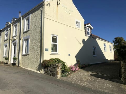 White Lion with driveway to the side and a small flower bed