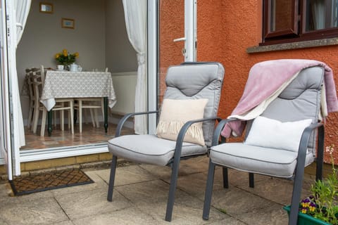 Outdoor seating for two with cushions and throw