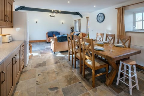 Dining table and chairs laid for lunch in the kitchen