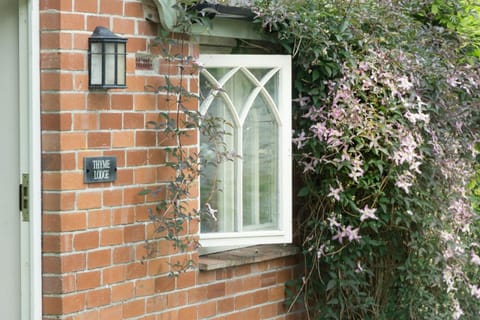 Thyme Lodge with clematis around the window