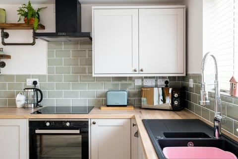 Oven, sink, wall cabinets, floor cabinets, toaster, microwave