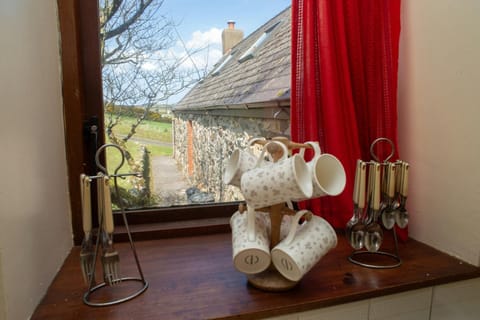 Decorative detail of windowsill with mug stand and view