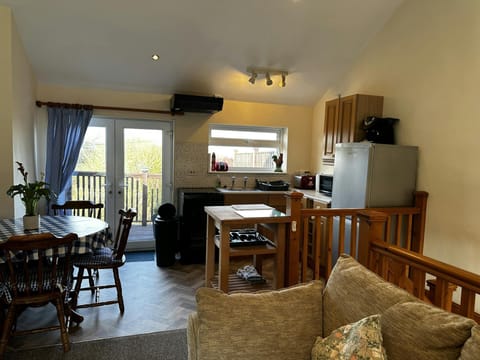Kitchen/dining area; fitted kitchen with dining table and chairs, sofa