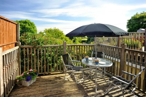 First floor balcony with seats and an umbrella