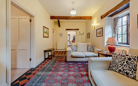 Two two seater sofas and table with a lamp