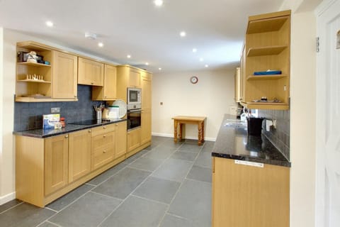 Kitchen with workspace either side of room.