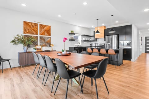 Cook, dine, and gather! The sleek kitchen and huge table make mealtime extra special.