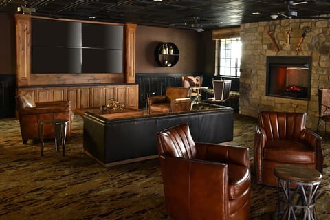 Unwind by the glowing fireplace in rich, leather lounge seating.