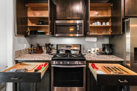 Fully stocked chef`s kitchen with a gas range and all the essentials for home-cooked meals.