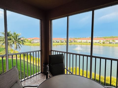 Screened lanai w/ dining table and lake views
