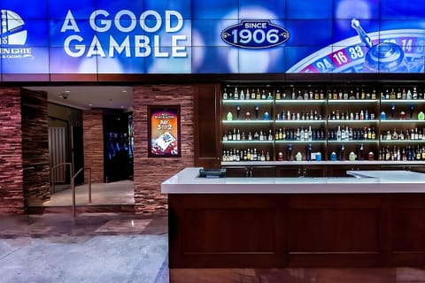 Sip crafted cocktails beneath a dramatic, illuminated feature wall.