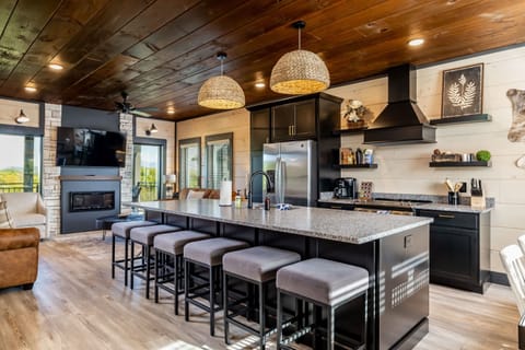 The grand kitchen island offers plenty of seating for conversation and late night snacks.