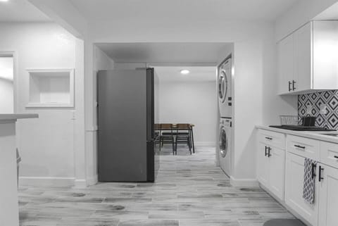 Modern kitchen with washer/dryer and a cozy dining area.