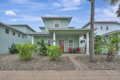 Charming coastal cottage with tropical landscaping and inviting front porch