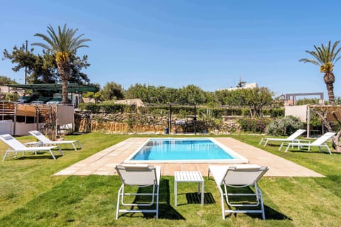 Relax by your private pool surrounded by lush greenery and sunshine