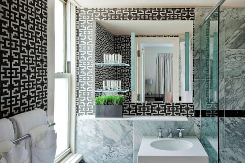 Refresh at a chic marble vanity with bright natural light.