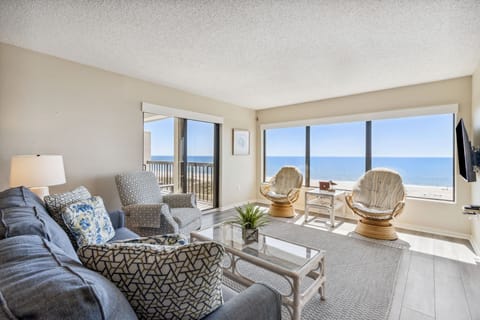 Enjoy Breathtaking Views on Three Sides in this Stunning Living Area with Two Private Balconies and a Flat Screen TV