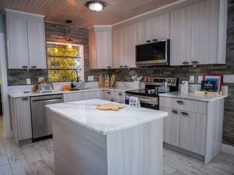 Another view. Cabinets stocked with pots, pans, tupperware, bowls, spices.