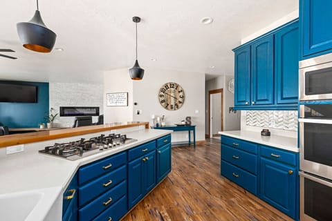 Designer Kitchen Remodel by Wrecked & Refined - Modern Lighting & Backsplash with City Views