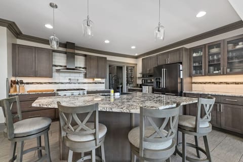 All stainless steel appliances: fridge, oven (with temp probe), microwave, 4 burner Thermador stove with electric griddle and ventilation, and double stack dishwasher